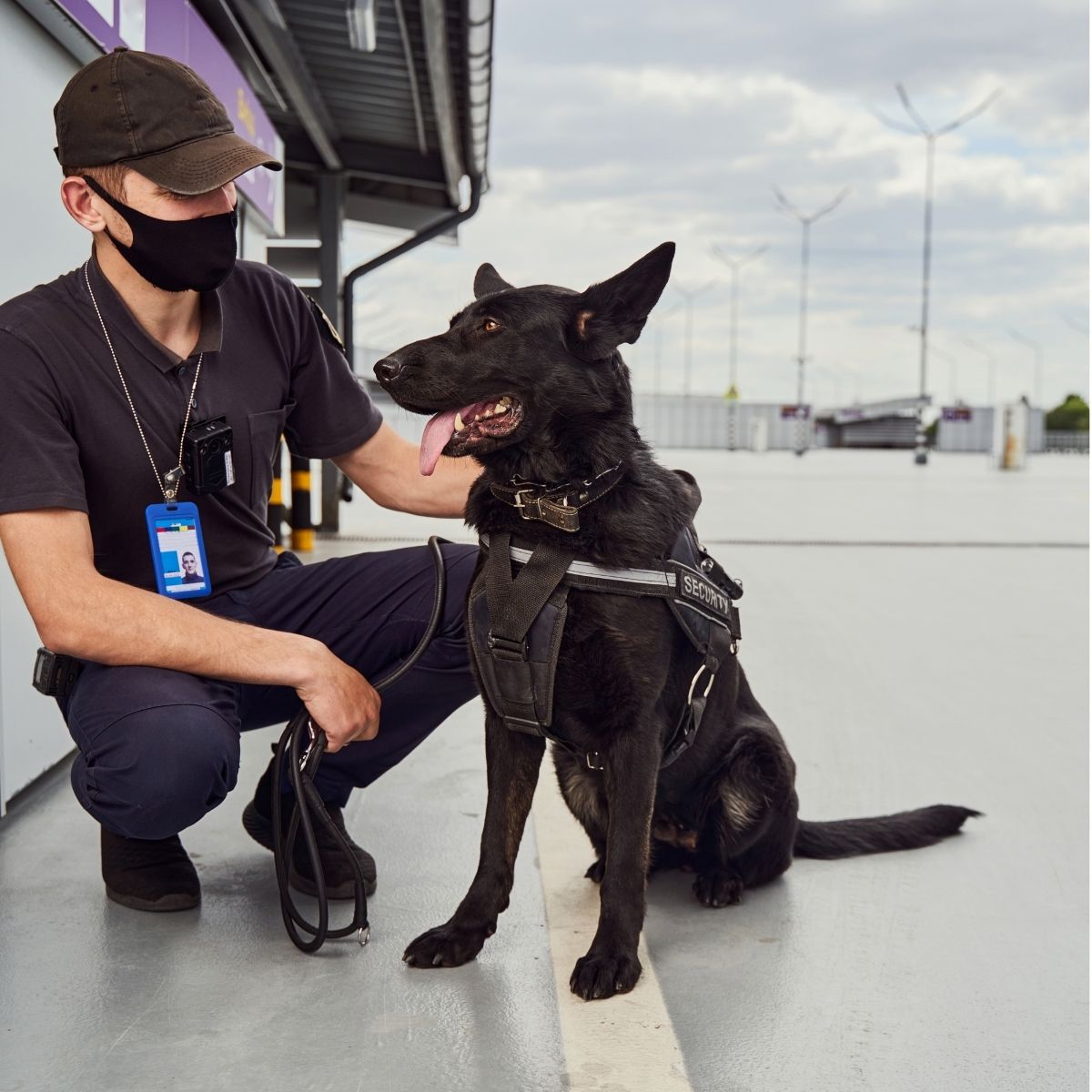 Agent de sécurité cynophile en patrouille avec son chien dans un aéroport. Agent de sécurité cynophile en patrouille.