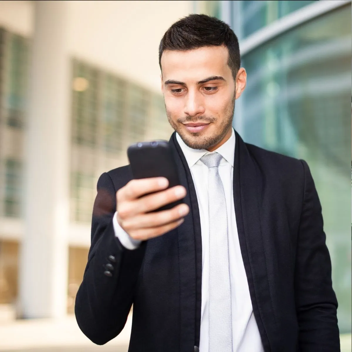Agent de sécurité consultant son smartphone pour gérer les affectations. Agent de sécurité consultant son smartphone.